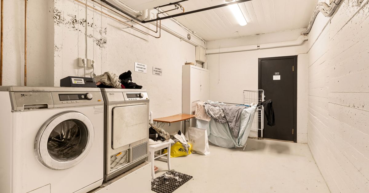 Spacious laundry room featuring washing machine and dryer with visible piping.